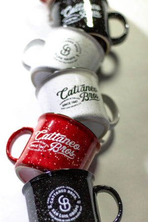 Stacked colorful Cattaneo Bros enamel coffee mugs