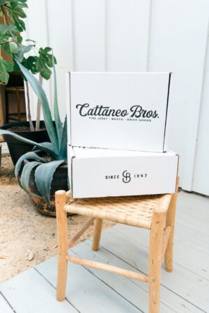White Cattaneo Bros. boxes on wicker chair